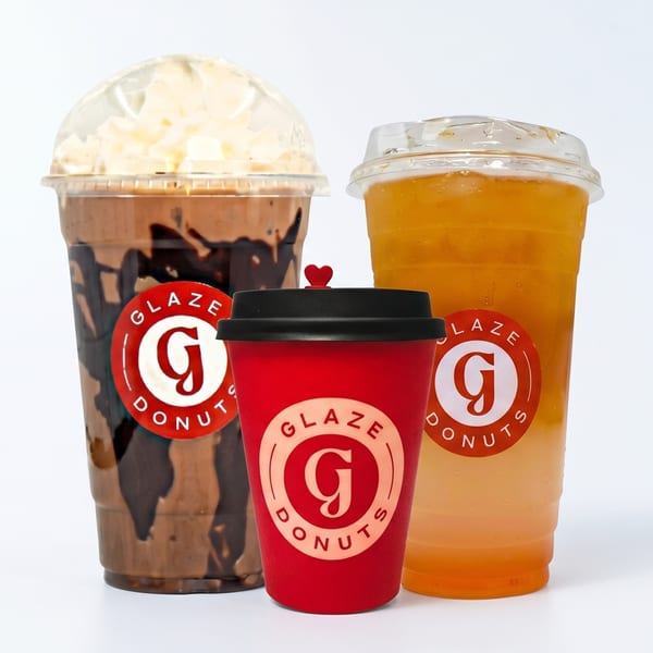 Three Glaze Donuts branded drinks: a chocolate shake, a red coffee cup, and an iced tea.